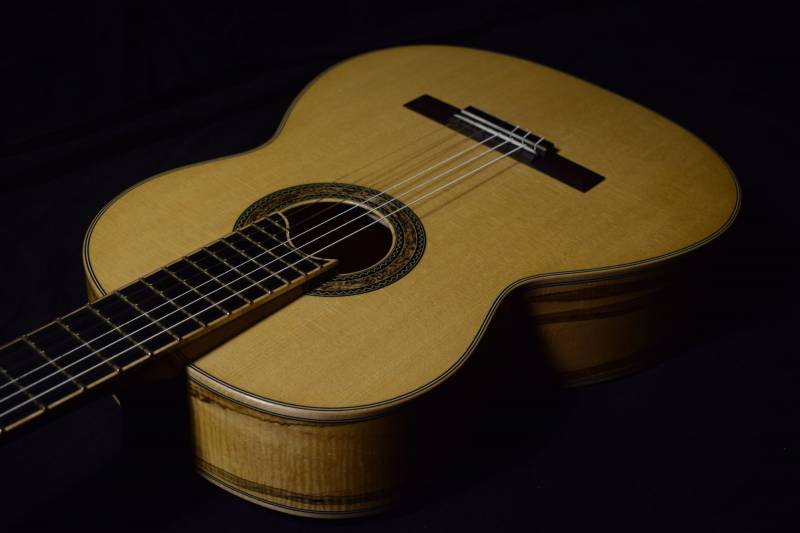 The nut is 51mm wide. Just a tiny bit more narrow of a string spacing