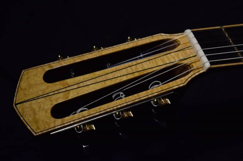 A three piece maple head veneer on the front with black veneer borders