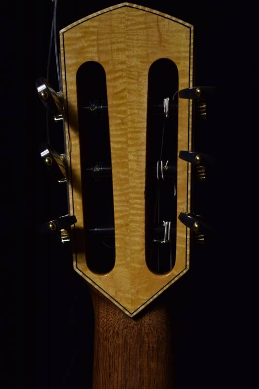 Figured Maple with maple binding and a black purfling accent