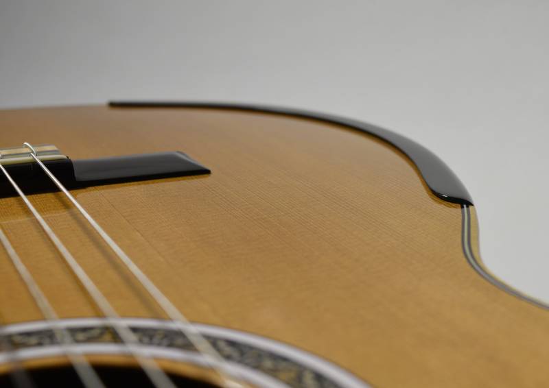 Flushed with the natural edge of the guitar