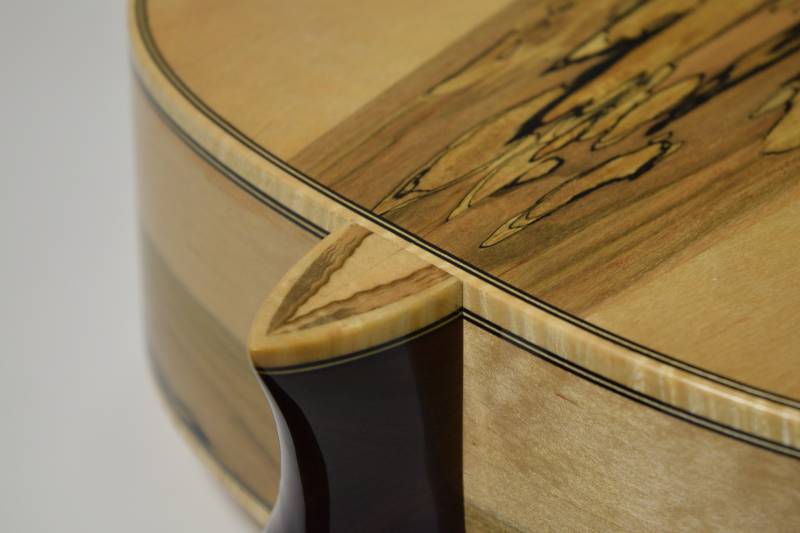 Purfling under the heal cap rests in line with side purfling as ususal