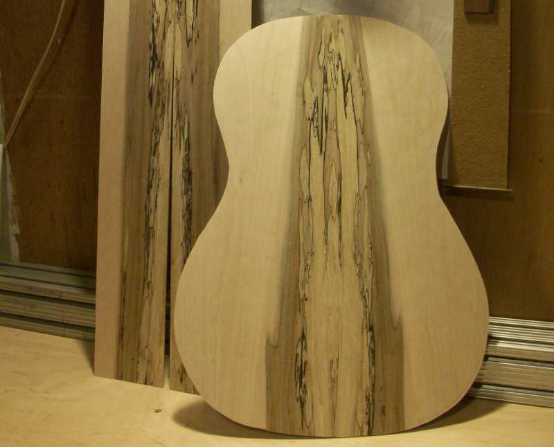 The formation of the back and side set was achieved with a double book matching. So it's technically a four piece back