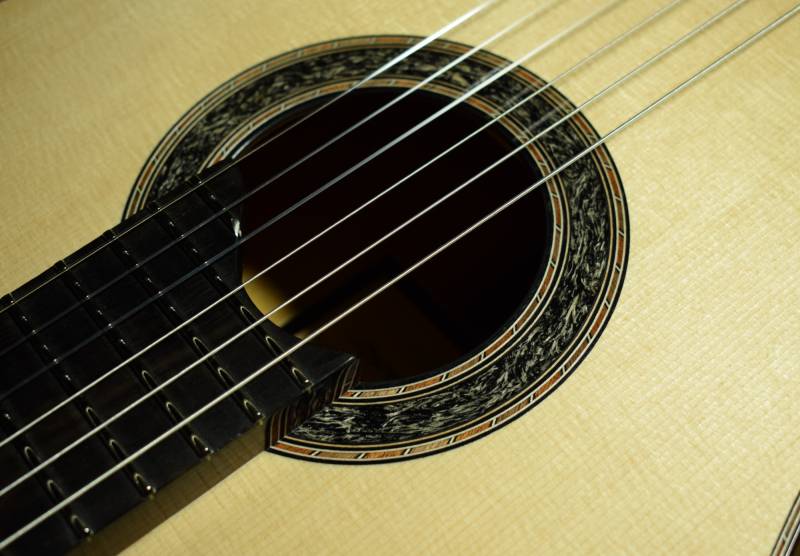 Wood conglomerate with a mahogany and walnut purfling design