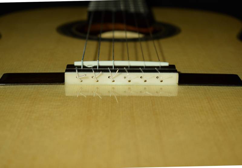 12 hole tie block with bone guard to prevent string wear