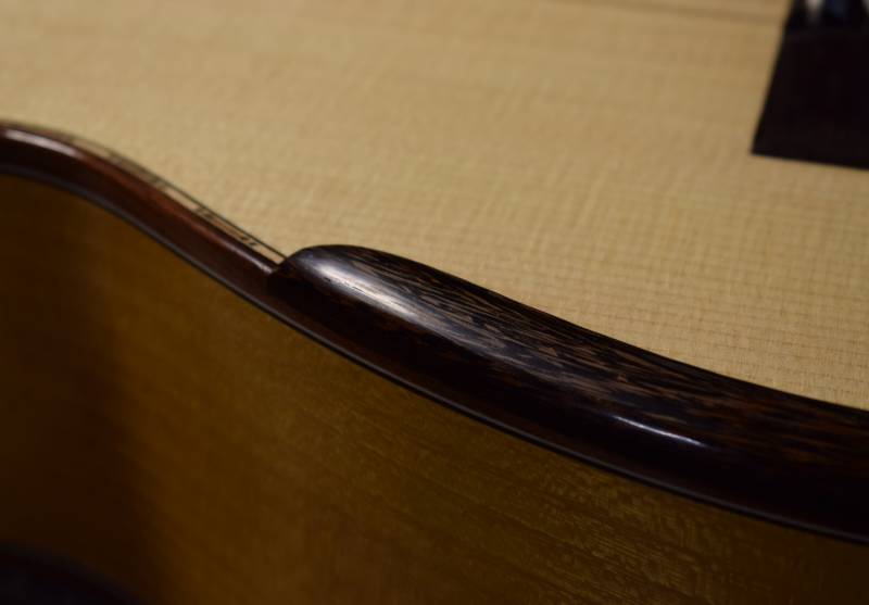 Closeup of wenge grain pattern and armrest profile