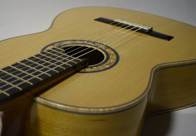 The neck is exposed about 1/2" at the 12th fret to facilitate reach to the higher frets