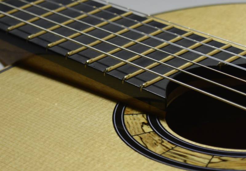 A previous customer asked me to make him a rosette out of a spalted piece of oak firewood and I used it on a few guitars.