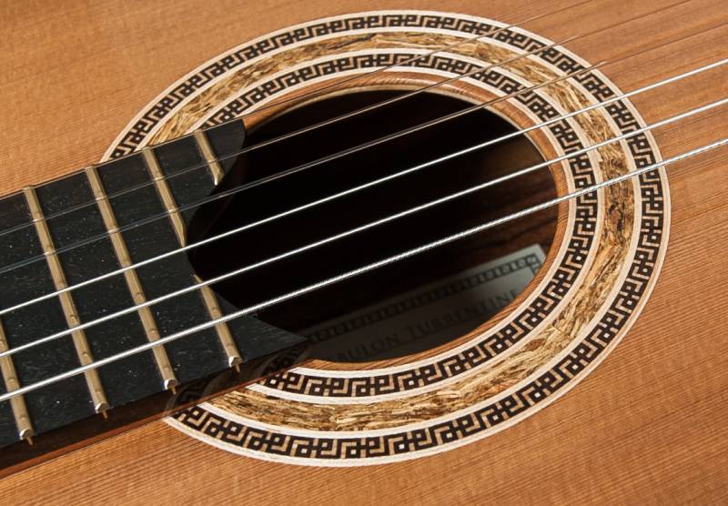 Guitar Rosette No. 25 This my first mosaic border design surrounding a wood conglomerate. Any guesses on what makes the center ring?