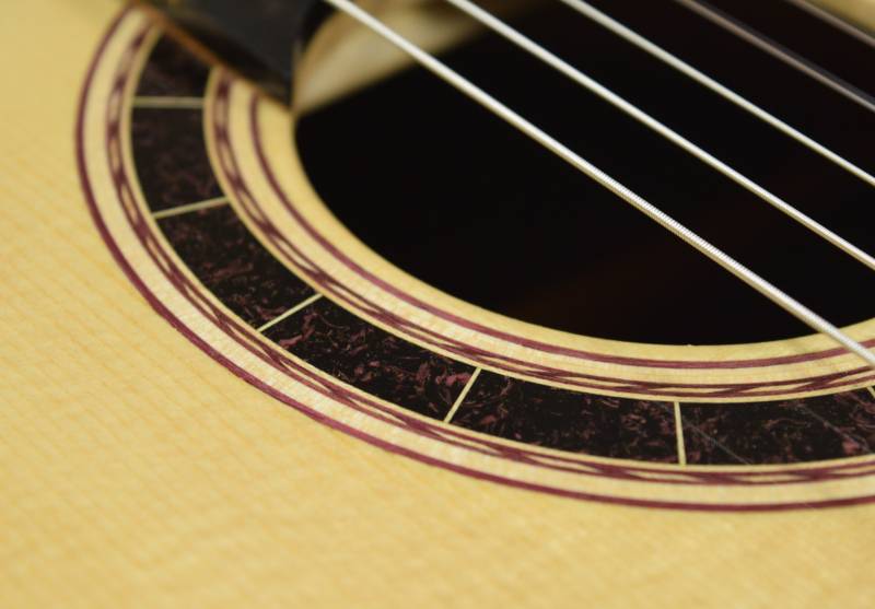 This guitar was the first attempt I made at a conglomerate inner ring. It's a mixture of ebony and purple heart
